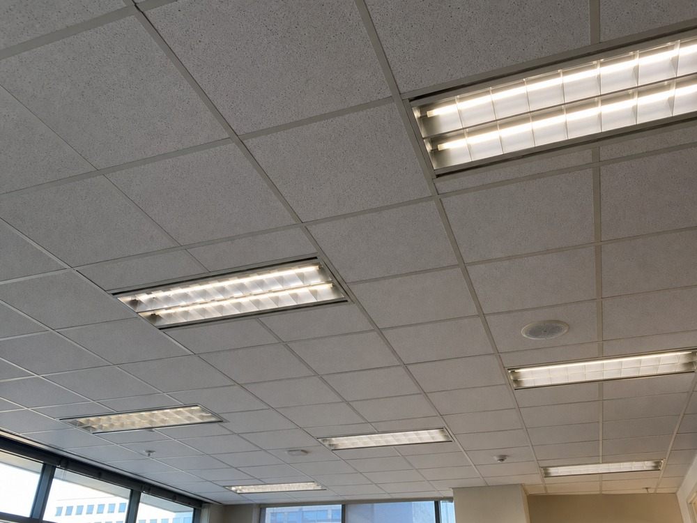 Before: Old fluorescent strips to clean panel lighting, City of London