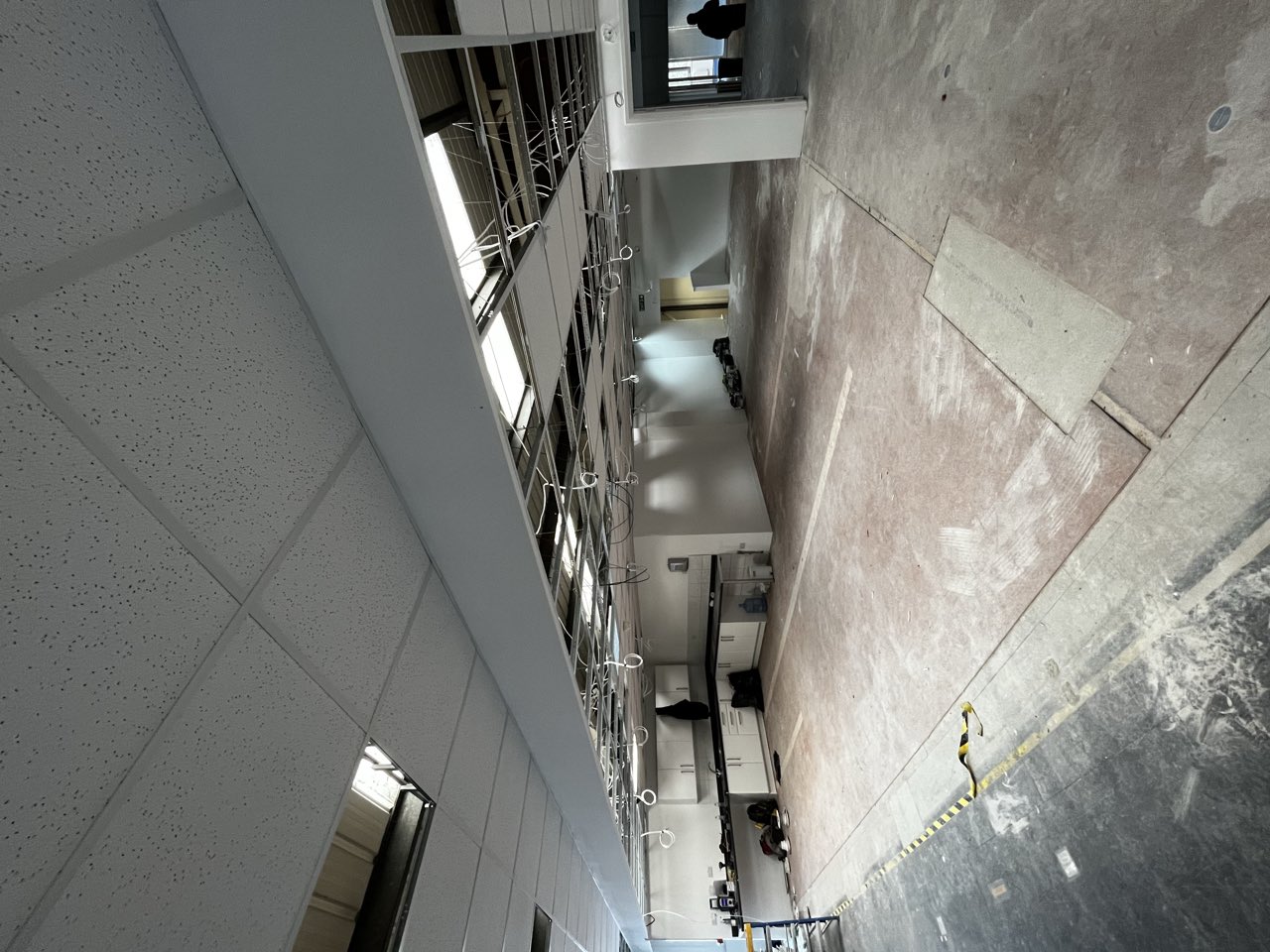 Before: Old strip lighting to bright, compliant commercial panels, London